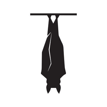 Black silhouette of a bat hanging upside down, spooky Halloween vector illustration isolated on white background
