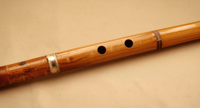 Natural bamboo bansuri flute with polished surface and finger holes