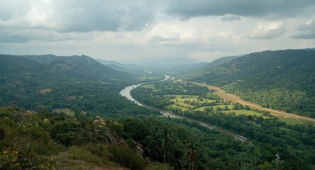 Obraz premium Wide Open Valley with a Meandering River and Lush Vegetation