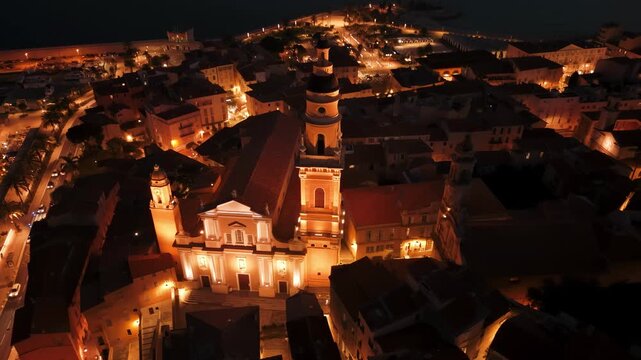 Basilique Saint-Michel Archange and mosaic Parvis square in Menton at night, overhead nadir, France, drone