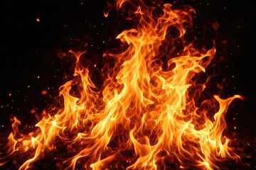 Fototapeta premium Close up of realistic blazing fire flames with intense movement on dark black background