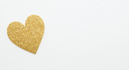 Fototapeta premium Glittery gold heart adding sparkle to minimal white plaster surface