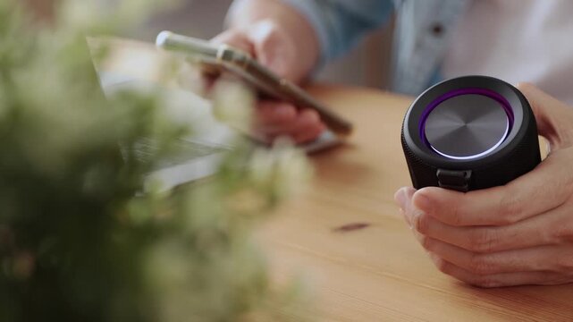 Track Shot Smart Speaker Virtual Assistant or Artificial Intelligence Concept by Connecting Smart Phone with Smart Speaker in Office