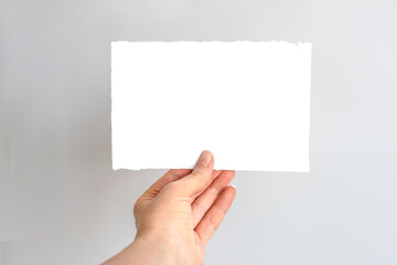Obraz premium Hand Holding Torn Grid Paper.