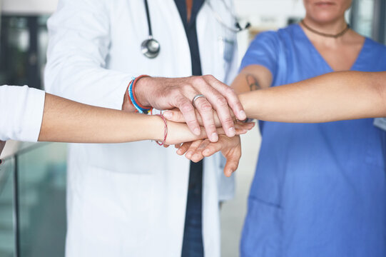 Hands together, partner and meeting with doctors in hospital for solidarity, synergy and healthcare. Medical, team and commitment with people in clinic for insurance, community and collaboration