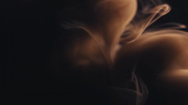 Abstract swirling smoke or vapor forms in a dark, moody atmosphere