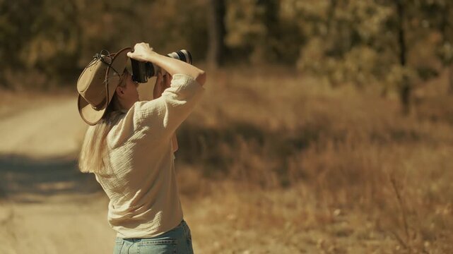 Photographer Taking Pictures With Digital Camera In Autumn Forest. Outdoor Hobby And Artistic Activity
