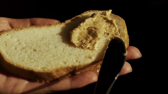 Spreading Peanut Butter On Slice Bread. Snack With Nut Paste