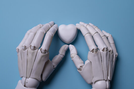 Robotic Hands Holding Heart Icon Representing AI in Healthcare Technology