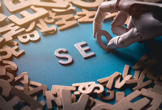 Robotic Hand Arranging Silver Letters to Spell SEO for Search Engine Optimization Concept