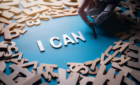 Robotic hand removing T from CAN'T leaving I CAN on a blue background