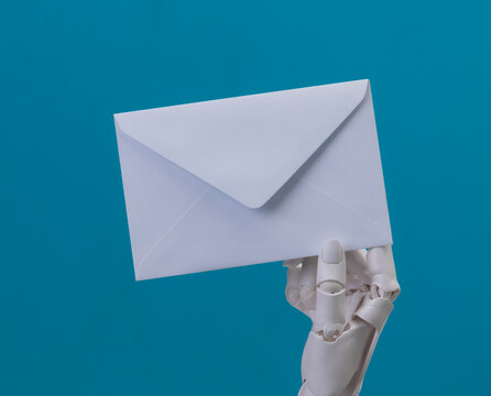Robotic Hands Holding a White Envelope on Blue Background for Email Concept
