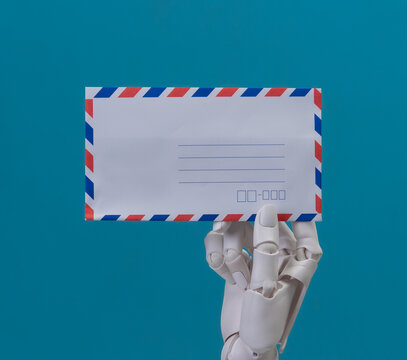 Robotic Hands Holding a White Envelope on Blue Background for Email Concept