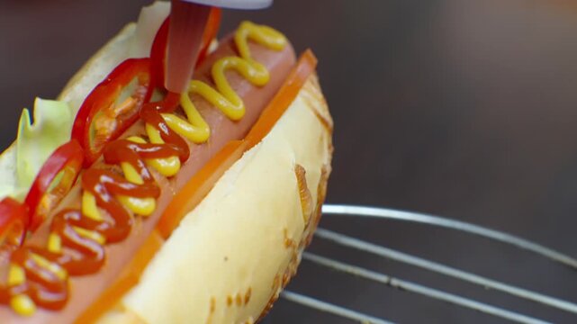 Squeezing Ketchup On Fresh Hot Dog With Mustard. Street Food Preparation
