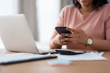 Hands, smartphone and woman in home, calculator and planning for income, documents or typing....