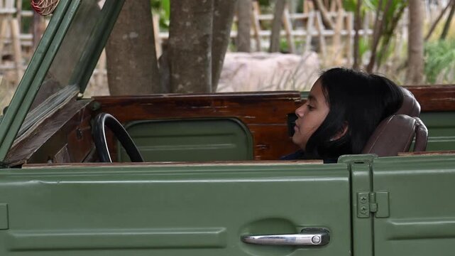 LATINA GIRL DRIVING A CAR