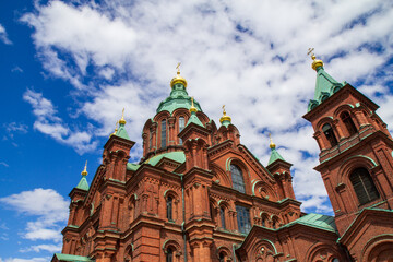 Eastern Orthodox cathedral with red brick and green domes © Michael Persson
