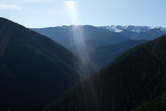 Sunflare with scenic view of Olympic National Park mountains