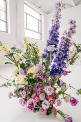 Colorful floral arrangement with purple larkspur and roses