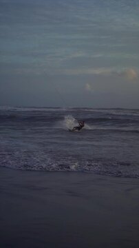 Kiteboarder with Kite Line Surfing Waves at Canggu Beach Bali Evening