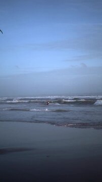 Kitesurfer Riding Ocean Waves at Canggu Beach Bali at Dusk