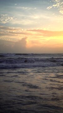 Distant Kiteboarder in Ocean Waves at Sunset Canggu Beach Bali