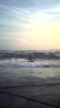 Kitesurfer Riding Waves at Canggu Beach Bali with Cloudy Sky