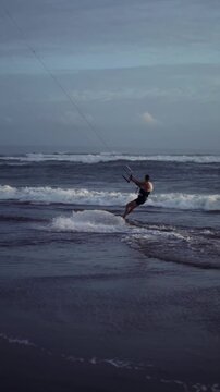Man Kitesurfing on Ocean Waves at Canggu Beach Bali Close Up