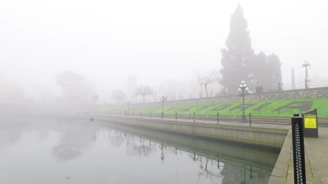 Victoria, BC, Canada &ndash; April 1, 2026: Foggy Inner Harbour with floral sig