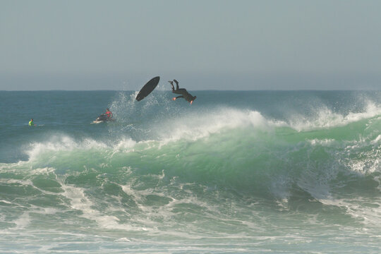Big wave surfing wipeout in Nazar&eacute;, Portugal, surfer falling from board at Praia do Norte.