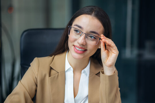 Happy young caucasian business woman in glasses head shot portrait. Thoughtful Black businesswoman looking away thinking over project tasks