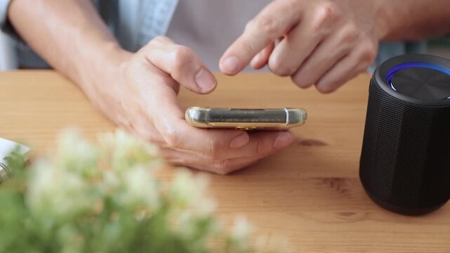 Track Shot Front View Smart Speaker Virtual Assistant or Artificial Intelligence Concept by Man Connecting Mobile Phone with Smart Speaker