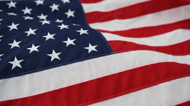 American flag waving in the wind with stars and stripes