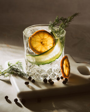 close up picture of a gin and tonic lit up in a studio