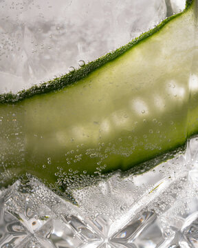 close up macro cucumber in a glass of gin and tonic