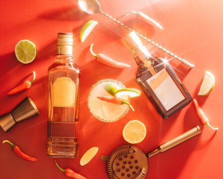 alcoholic bottles laying with ingredients and mixers shot in a studio