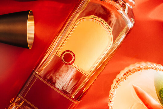 close up of alcoholic bottle laying with a cocktail and mixers