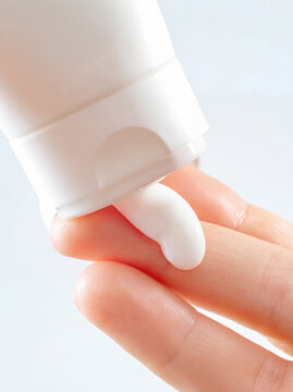 Squeezed cream in hand, macro shot