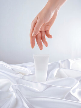 hand and hand cream on a white background