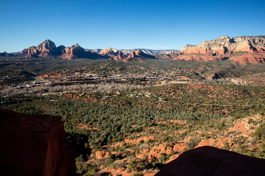 Panoramic view of desert town surrounded by red rock mountains