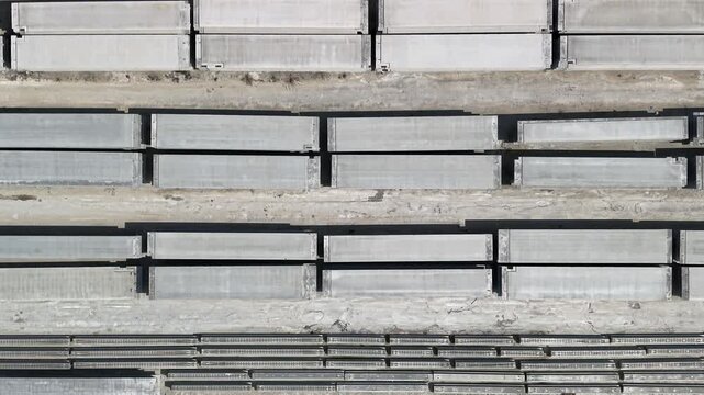 Rows of prefabricated concrete panels, beams and pillars at cement plant storage