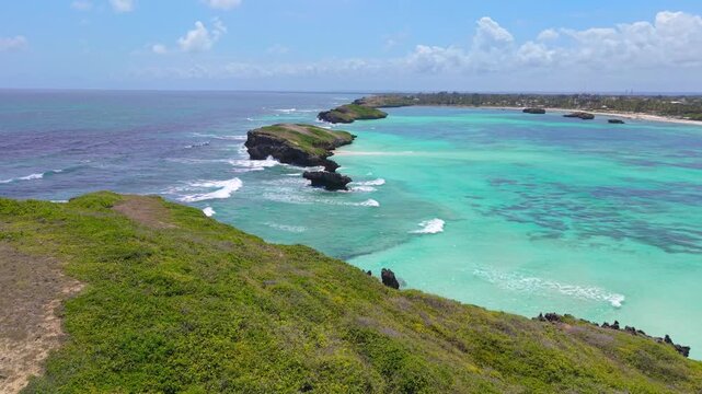 Aerial view of turquoise ocean water and rocky islands with green vegetation along the coast of Watamu Beach, Kenya.