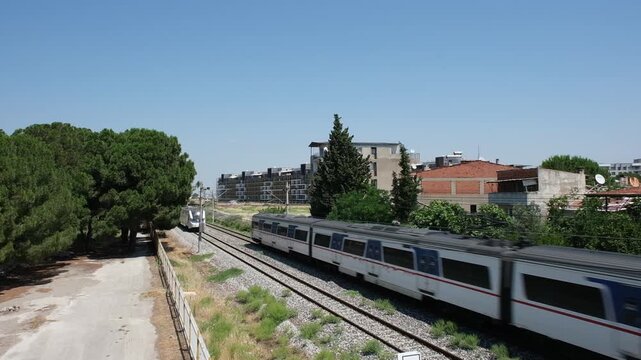 In T&uuml;rkiye, in &Ccedil;iğli, İzmir, there is a railway line and two Izban trains passing in opposite directions.