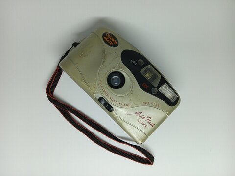 Tegal, INDONESIA, 17 March 2026 - Beige Canon Auto Flash compact film camera with strap. Suitable for vintage photography, camera collections, and retro themed designs.