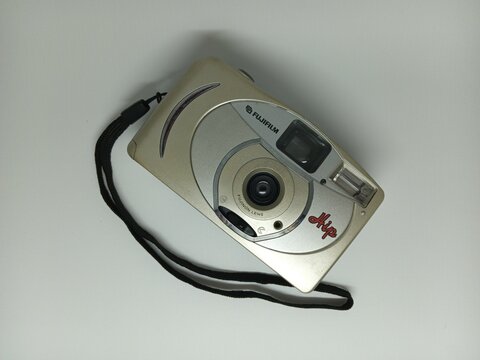 Tegal, INDONESIA, 17 March 2026 - Fujifilm skip hi8 disposable film camera featuring a stylish camera strap. Ideal for retro photography enthusiasts and vintage camera collectors.