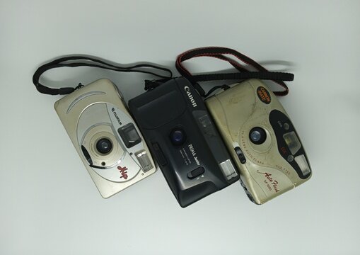Tegal, INDONESIA, 17 March 2026 - Three disposable film cameras on high angle. Suitable for marketing vintage camera accessories, photography event promotions, and retro-themed social media campaigns.
