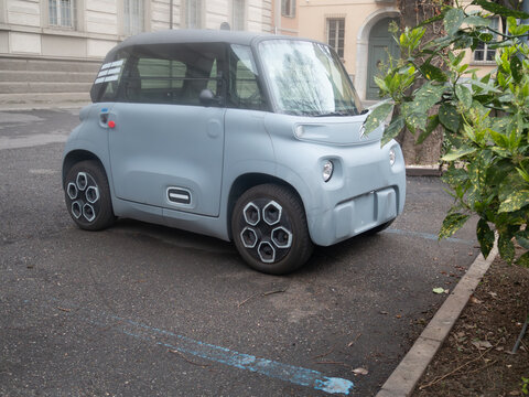 Citroen Ami electric microcar parked on urban street, offering sustainable mobility and smart city transportation