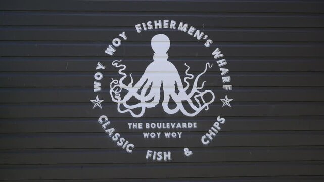 Close-up of fish and chips shop logo featuring octopus graphic and lettering.