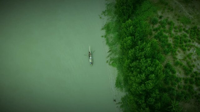 Top View of Small Fishing Boat Near Green Riverside | Aerial Drone Shot in Bangladesh 4k