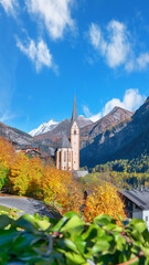 Fototapeta premium Astonishing autumn landscape at Heiligenblut with St Vincent Church near Grossglockner mount .